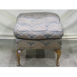 A stool of square form with upholstered seat, raised on beechwood cabriole supports