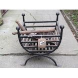 An unusually small ironwork fire basket with ball finials and flattened feet, together with two