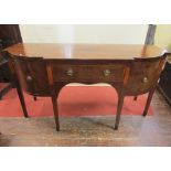 A Georgian mahogany breakfront D end sideboard, enclosing an arrangement of drawers raised on square