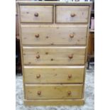 A good quality contemporary solid pine bedroom chest of two short over four long drawers, raised