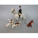 A Beswick equestrian figure of a huntswoman on a grey horse with dappled patches, together with