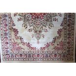 Kashmir rug, floral medallion design, ivory and gold ground, 175 x 120cm