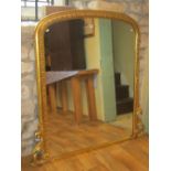A 19th century gilt framed overmantle mirror with arched and moulded frame and carved scrolling