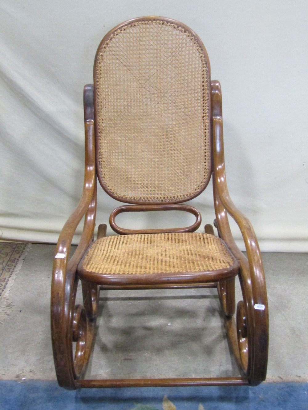 A vintage bentwood rocking chair, with scrolled frame and cane panel seat and back (unmarked but - Image 2 of 2