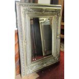 A large contemporary reproduction wall mirror of rectangular form the stepped and moulded frame with