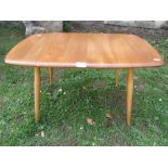 An Ercol blonde elm and beechwood occasional table of rectangular form with moulded outline and