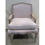 A Fauteuil with upholstered seat, back and loose feather filled cushion within a shaped and