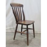 A harlequin set of four Windsor stained elm and beechwood lathe back kitchen chairs