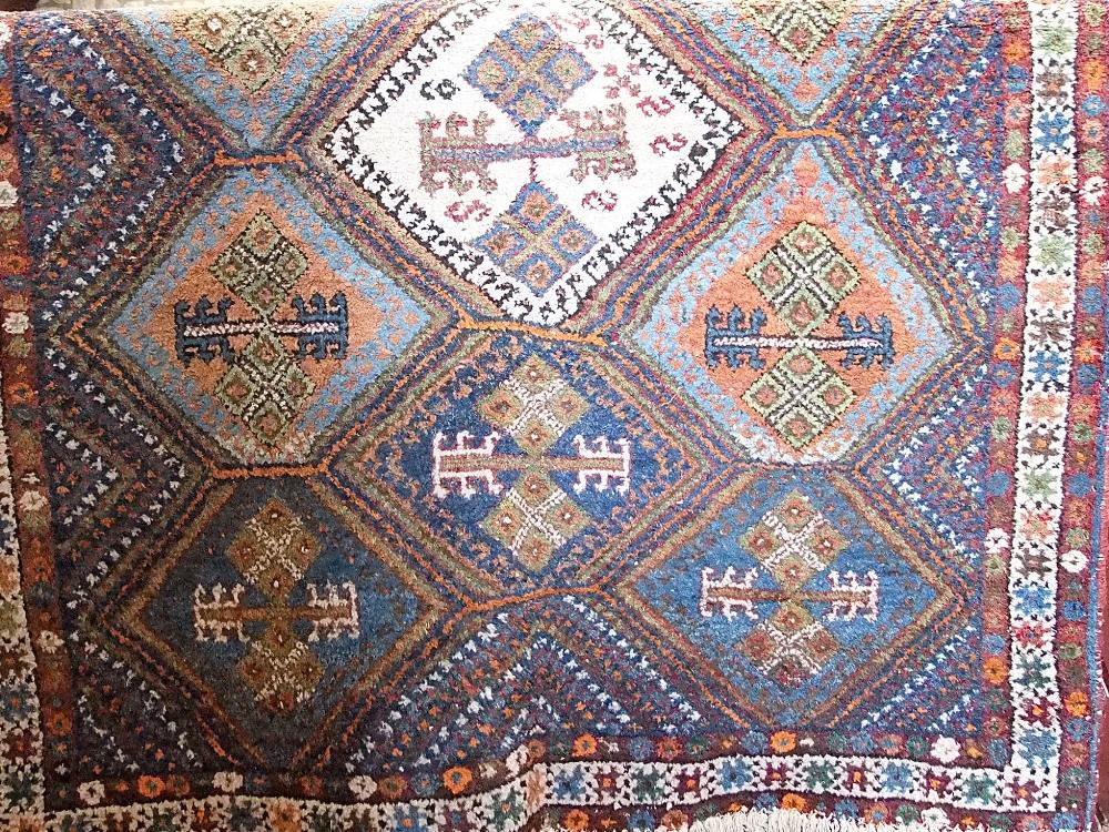 Turkish full pile rug with geometric medallions upon a blue ground, 200 x 145cm