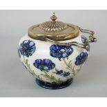 An early 20th century Moorcroft Macintyre biscuit barrel with moulded and painted blue poppy