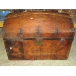A 19th century pine domed top chest with side carrying handles and hinged lid, retaining its