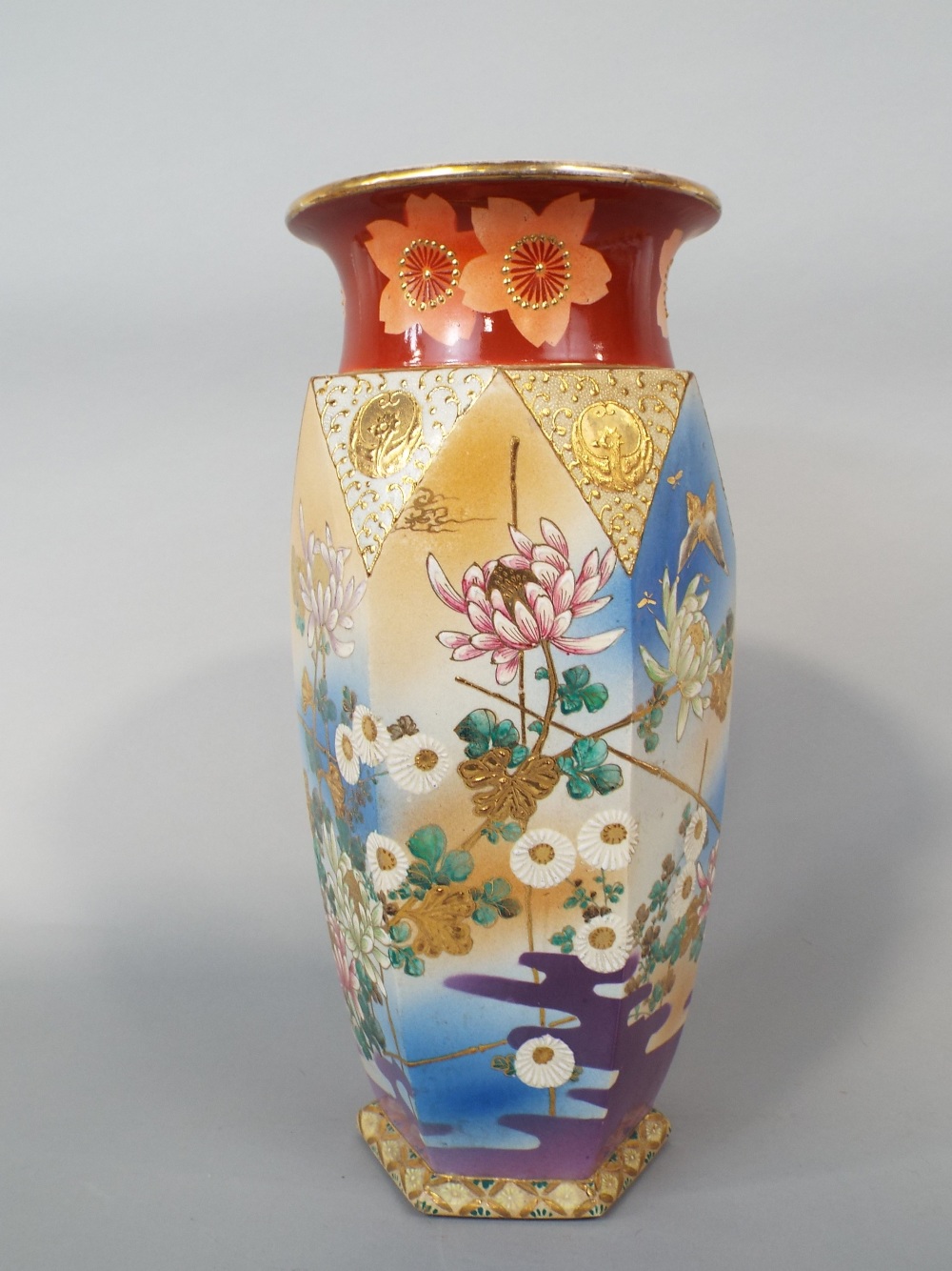 A large early 20th century satsuma vase of hexagonal form with painted and gilded floral detail,