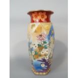 A large early 20th century satsuma vase of hexagonal form with painted and gilded floral detail,