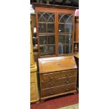 A good quality Edwardian mahogany bureau bookcase in the Georgian style, the upper section