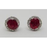 Pair of ruby and diamond cluster stud earrings in 18ct white gold, 2.6g total