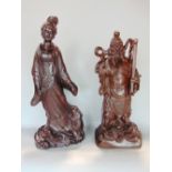 Pair of Chinese hardwood carvings, one a Geisha girl with a rodent at her feet, 54 cm high, the