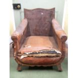 An Edwardian library/lounge chair with original leather upholstered finish (poor), the framework