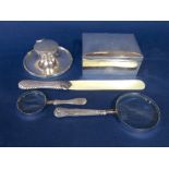 A good collection of desk silver to include a capstan inkwell, ivory and silver page turner, two