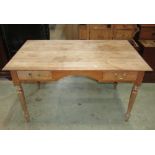 A Victorian style pale mahogany writing table, the rectangular top with moulded outline over two