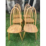 A set of six Ercol blonde elm and beechwood high hoop and stick back dining chairs raised on splayed