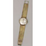 Vintage 9ct Tissot gent's dress watch, the champagne dial with black baton markers upon a good