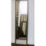 A gilt framed full length dressing mirror of rectangular form with bevelled edge plate, repeating