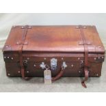 A brown leather suitcase with polished fittings