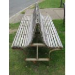 A twin (two sided) bench, with weathered timber lathes, raised on a painted steel frame, 150cm long