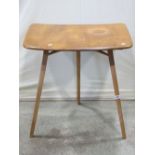 An Ercol blonde elm and beechwood extension table with moulded outline raised on three splayed