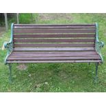 Two seat garden bench with stained timber lathes and decorative green cast ends, with pierced