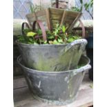 Two vintage galvanised two handled tubs/baths of oval form, together with a small wooden cart with
