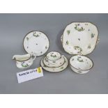 A collection of Aynsley teawares with printed and infilled chinoiserie style decoration of country