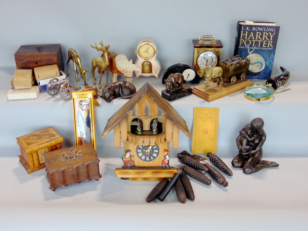 A mixed collection of miscellaneous items to include various clocks, sculptures of animals to