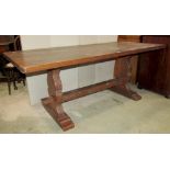 An Old English style oak refectory table, the rectangular top raised on a pair of shaped supports