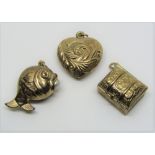 Three 9ct novelty charms comprising a heart and a hinged chest, both embossed with scrolled