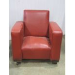 A vintage child's size club armchair with faux leather upholstery