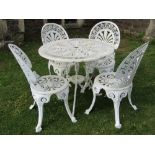 A cream painted Victorian style cast aluminium garden terrace table of circular form with four