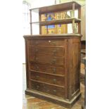 A Victorian oak chiffonier the lower section enclosing six drawers with Gothic tracery outline and