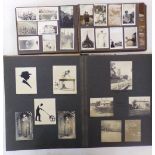 Three albums containing a collection of early 20th century black and white family photographs,