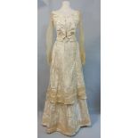 19th century two piece gown in cream silk with jacquard weave; bodice is boned with long bobbinet