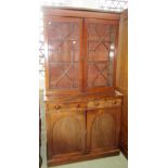 A 19th century mahogany library bookcase, the lower section enclosed by a pair of arched panel doors