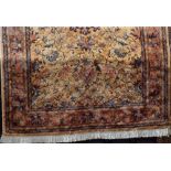 Keshan type full pile carpet with central blue floral medallion framed by further scrolled foliage