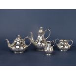 Good quality Victorian four piece tea service of lobed baluster form, engraved with scrolled foliage