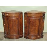 A pair of Victorian burr and figured walnut veneered floorstanding bow fronted corner cupboards,