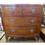 A small Georgian mahogany bow fronted chest of two long and two short drawers on swept supports with