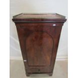 A 19th century mahogany pedestal cupboard with raised pierced brass gallery over and enclosed by
