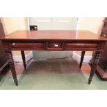 A good quality early 19th century mahogany side table enclosed by two cushion moulded drawers,