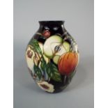 A Moorcroft vase of ovoid form with painted fruit and floral detail, with impressed and printed