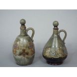 Two similar Royal Doulton stoneware bottles and stoppers, both with relief moulded Art Nouveau style