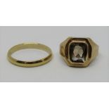 Two unmarked yellow metal rings; a smoky quartz dress ring and a wedding ring, 7.4g total (2)